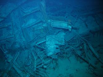 Wire mesh and twisted metal in debris field